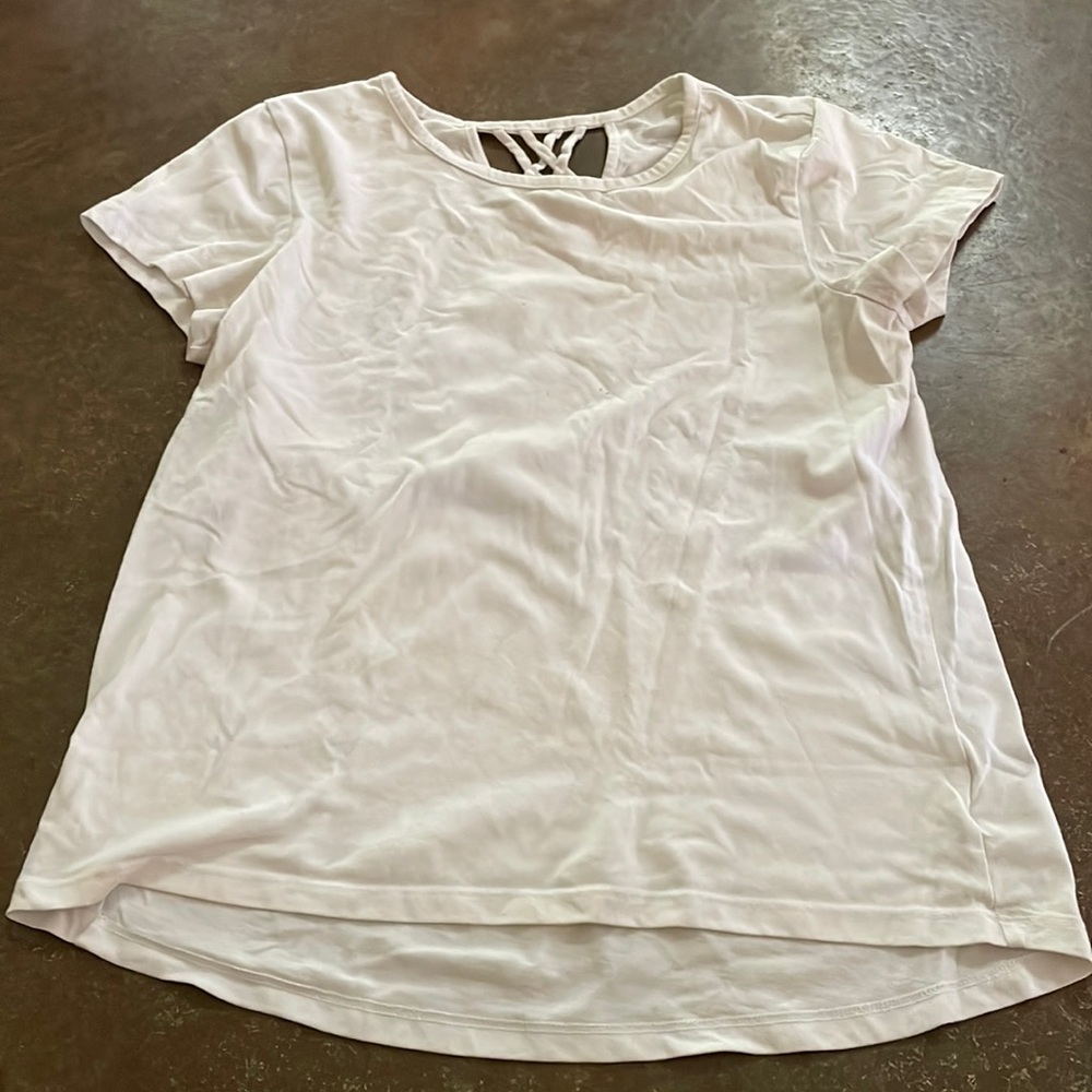 Plain white tee with small cross pattern on back
